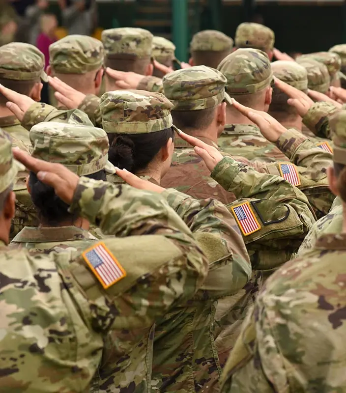 Rows of U.S. soldiers in uniform saluting